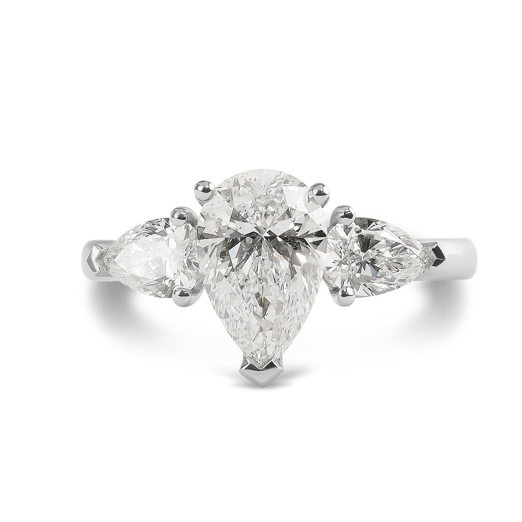 Diamond ring with pear-shaped stones on a white background