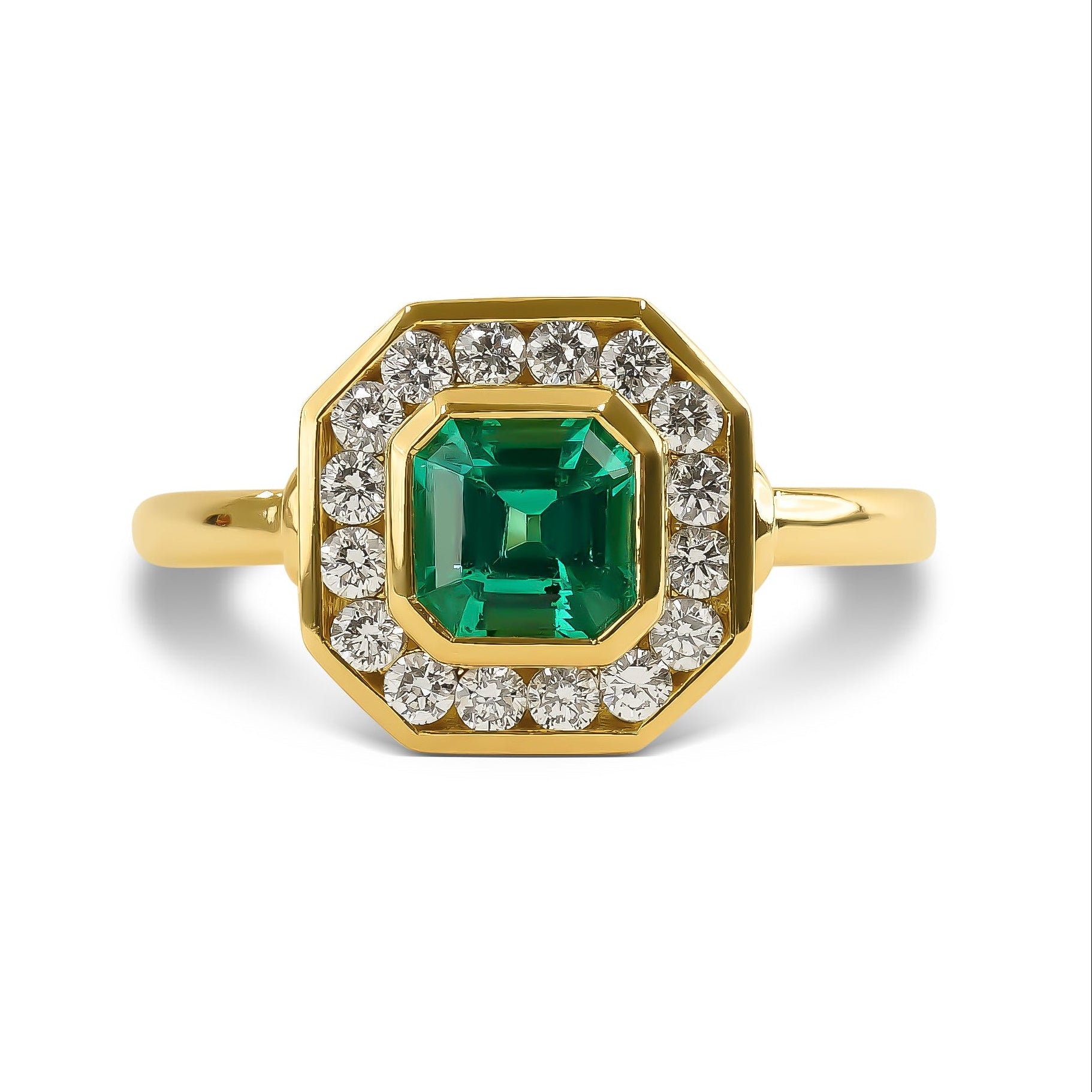 Gold ring with a green gemstone and diamond accents on a white background